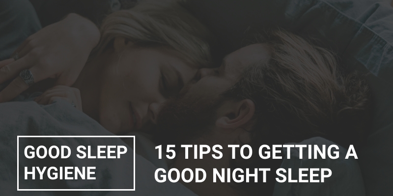 A loving couple practising good sleep hygiene, asleep in bed in a cool dark bedroom