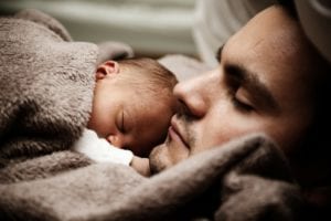 photo of man and baby sleeping
